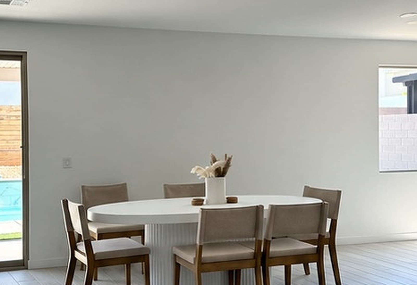 Plain white dining room wall before the slat wall